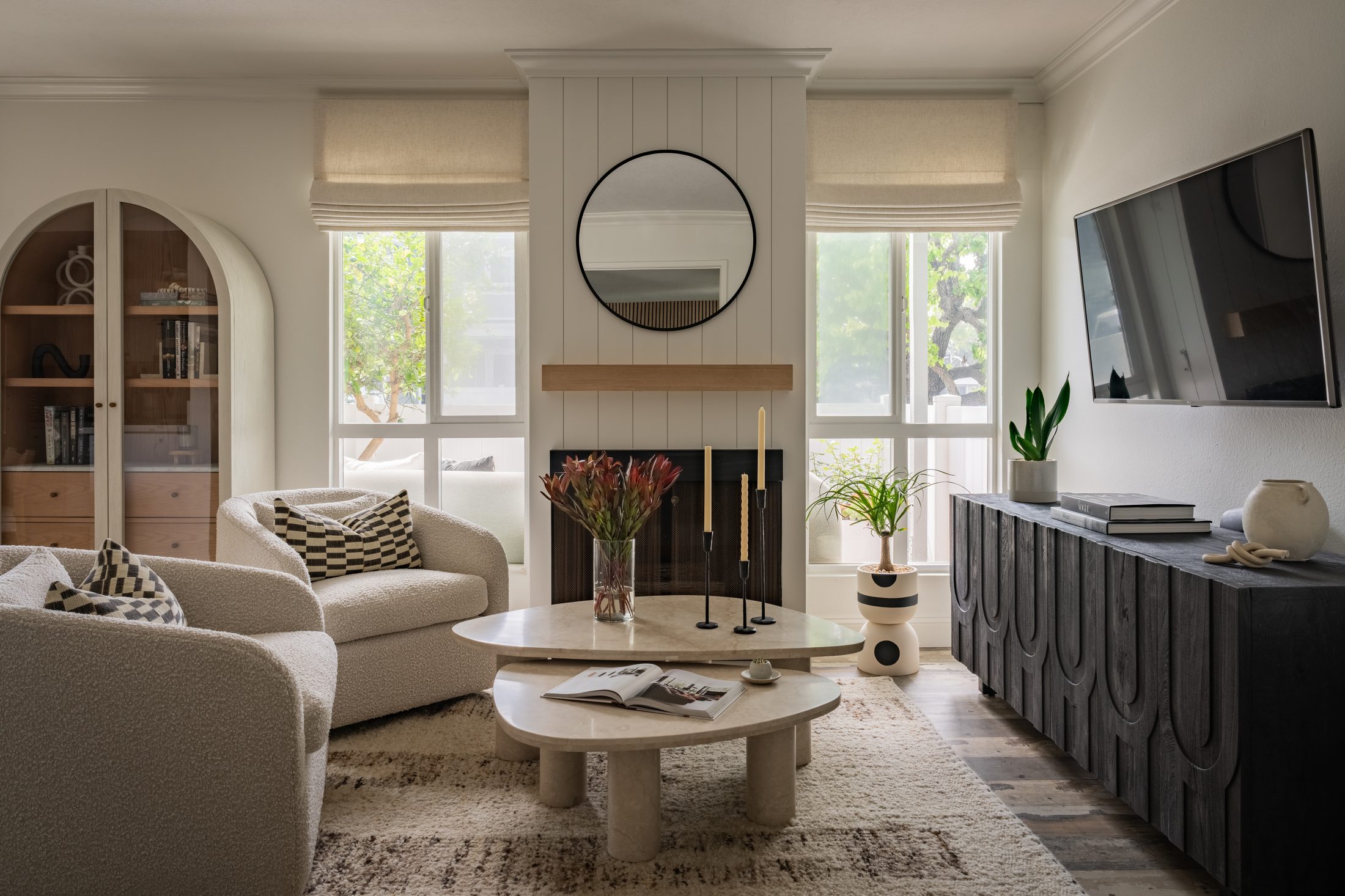 Refined living room with arched bookcase and fireplace — Shipwright Homes interior