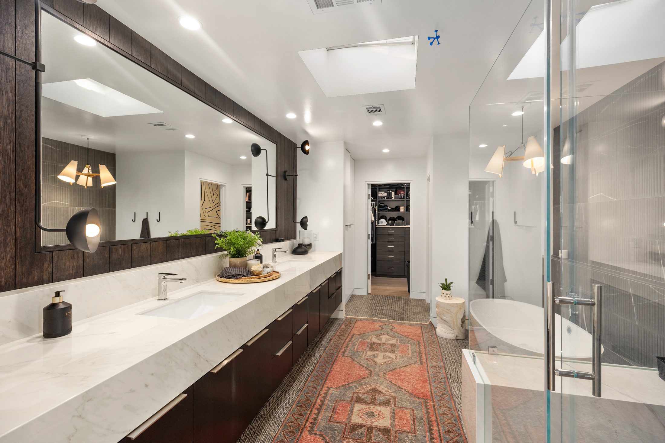 Custom master bathroom with terrazzo flooring and dark vanity