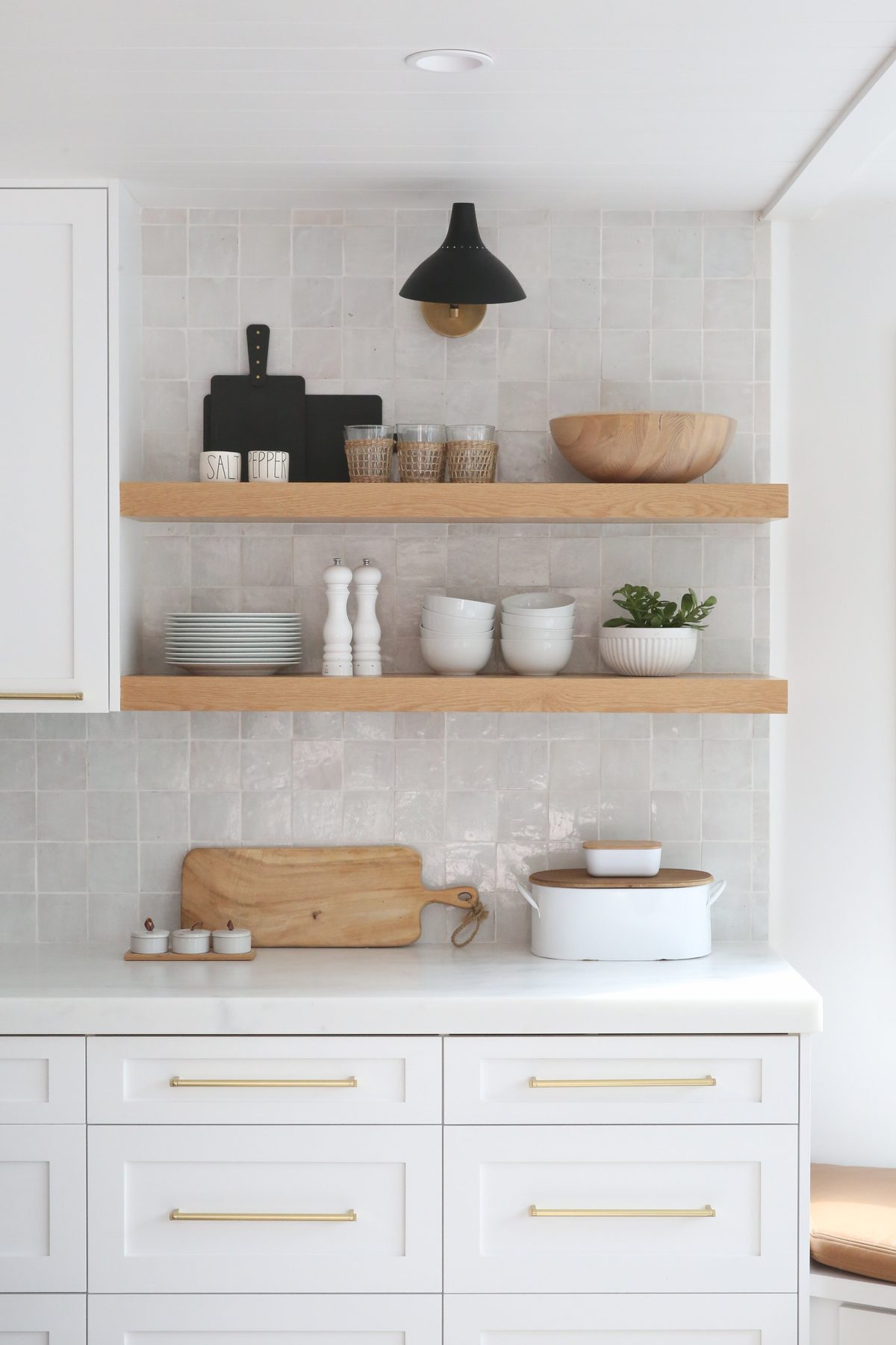 Custom built-in shelving and cabinetry with brass details