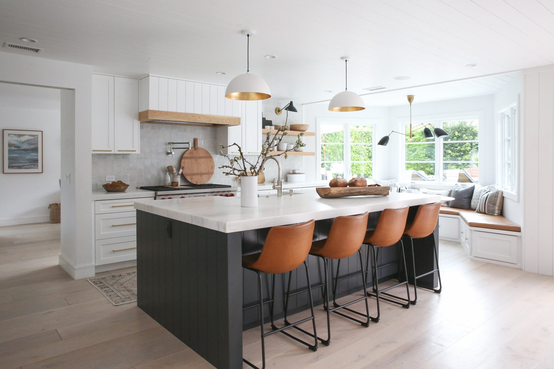 Full kitchen remodel with island, pendants, and leather counter stools
